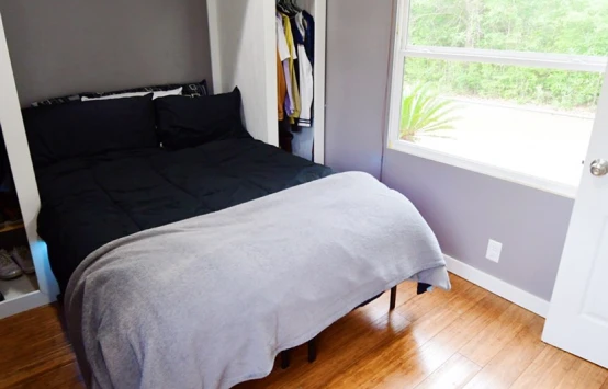 Bedroom with window beside the bed